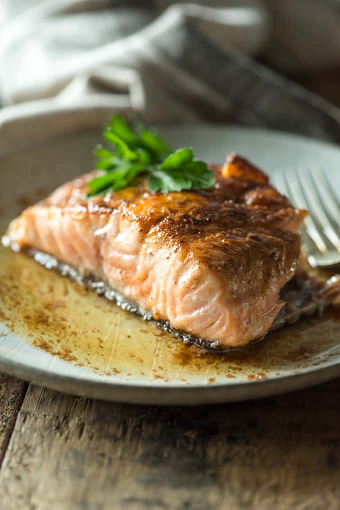 Salmon on a plate topped with parsley