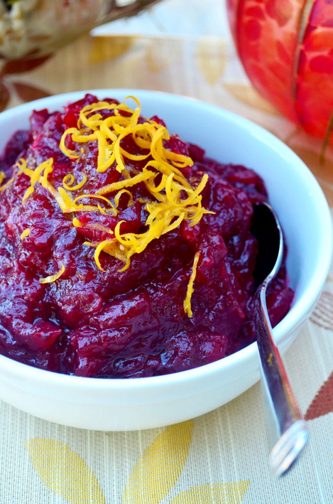 Thanksgiving recipes, cranberry sauce topped with orange zest in a white bowl