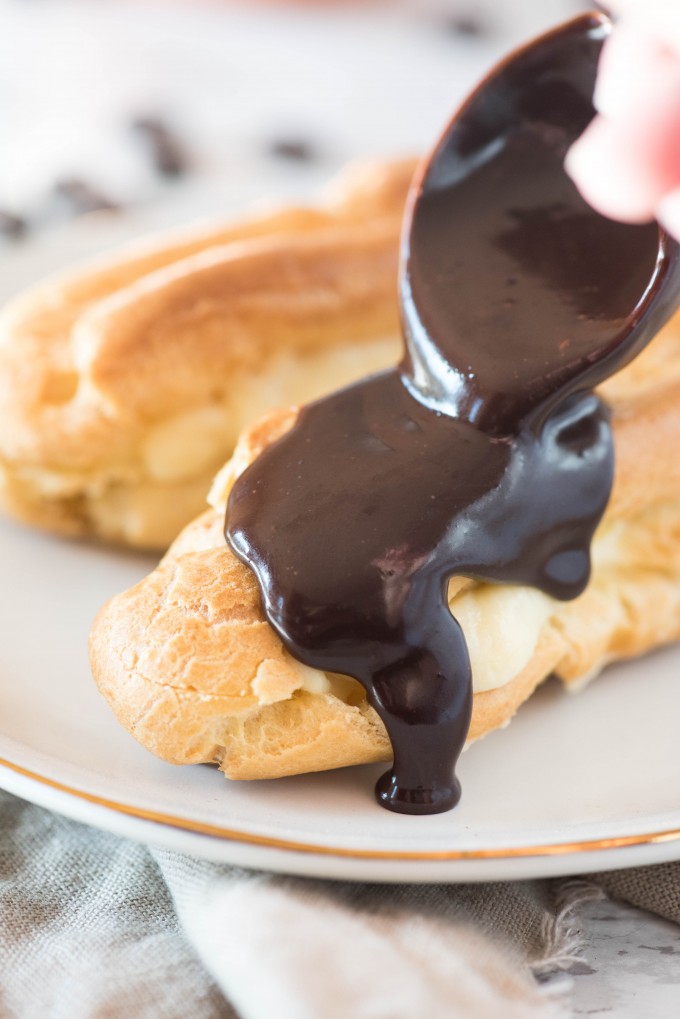 Forget the cake, pie and cupcakes, this easy Chocolate Eclair recipe will take you to French dessert heaven! #easychocolateeclairs #easydessertrecipes #frenchdesserts #chocolateeclairrecipe #gogogogourmet Easy Chocolate Eclair recipe on white plate