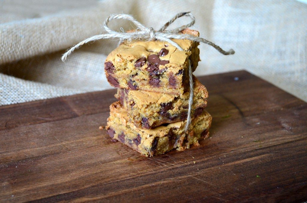 Chocolate chip blondies stacked on a board