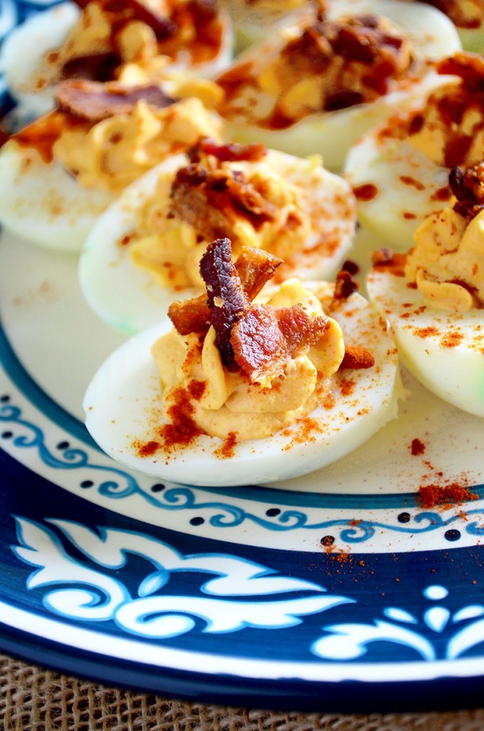 Boiled egg recipes - bacon sriracha deviled eggs on a blue plate