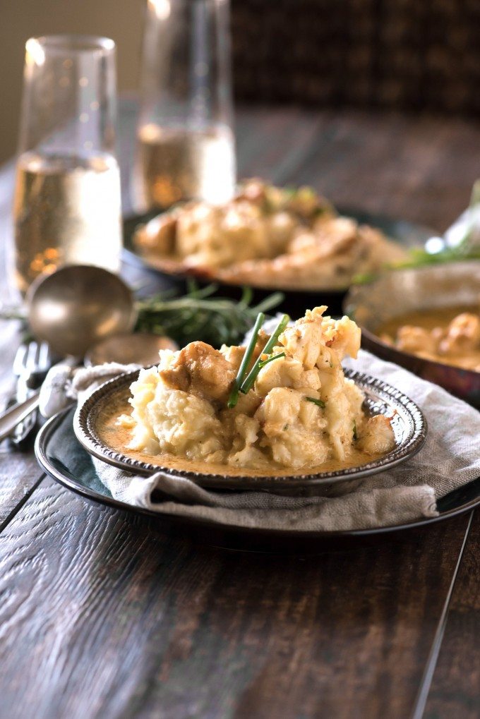 Lobster mashed potatoes in a bowl with herbs