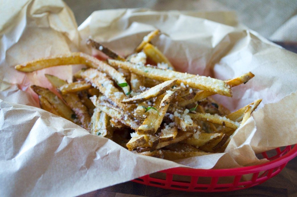 Forget the frozen fries, these homemade Parmesan Herb Fries are made with lots of garlic and fries in olive oil for a semi healthy side dish that everyone is sure to love! You won't believe how easy this recipe is! #gogogogourmet #parmesanherbfries #garlicparmesanfries #homemadefrenchfries