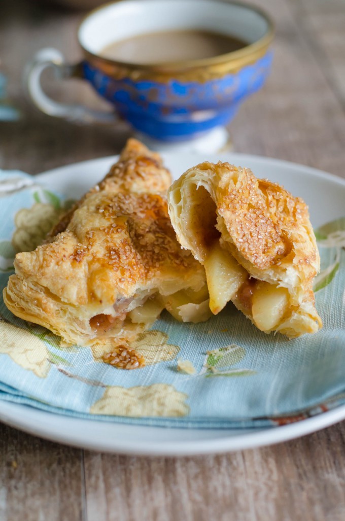 Apple turnover cut in half on a plate