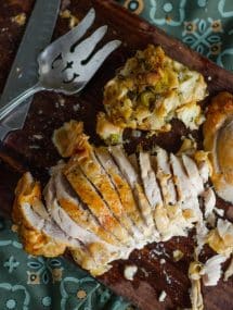 Oven roasted turkey breast cut into slices on a cutting board