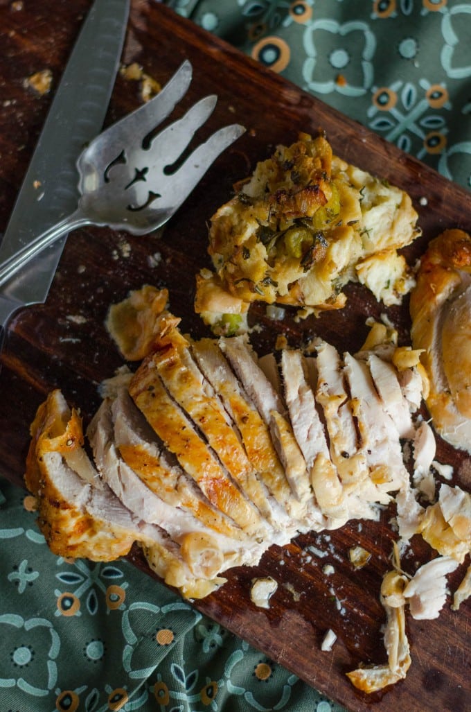 Oven roasted turkey breast cut into slices on a cutting board