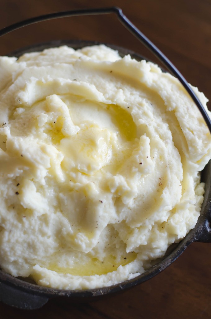 Whipped potatoes topped with butter in a bowl