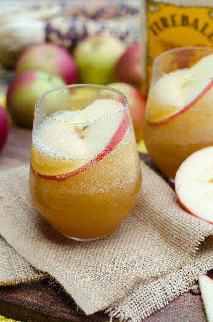 Apple cider fireball cocktail with a fireball bottle