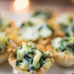 Spinach artichoke phyllo cups on a white plate as new years eve party food ideas