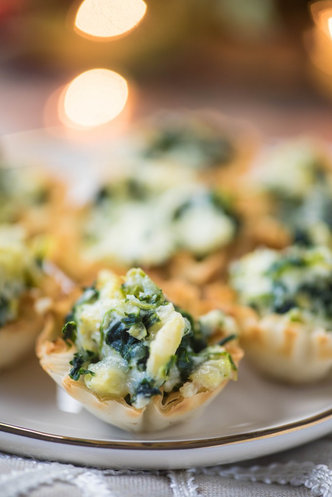 Spinach artichoke phyllo cups on a white plate as new years eve party food ideas