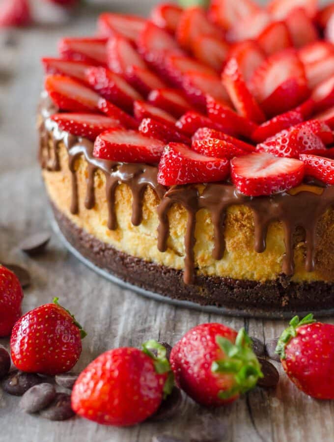 Chocolate Covered Strawberry Cheesecake - chocolate cookie crust, a layer of chocolate ganache, topped with a not-too-dense, not-too-sweet cheesecake, more ganache and fresh strawberries | Go Go Go Gourmet @gogogogourmet