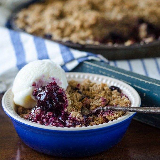 Best blueberry crisp recipe in a blue bowl with a spoon