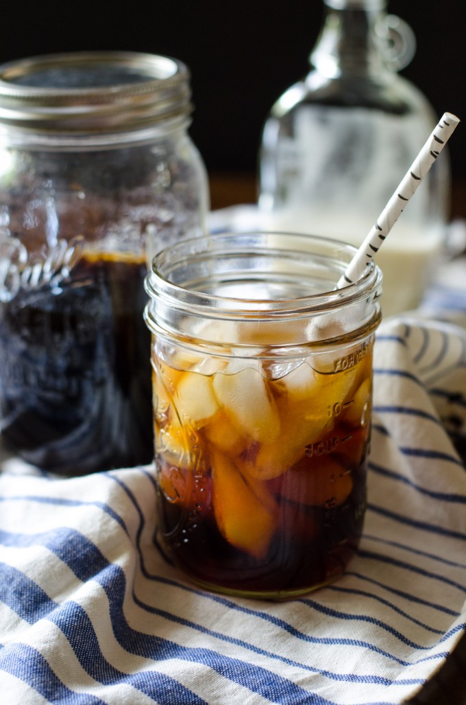 A mason jar with cold brew coffee and a straw