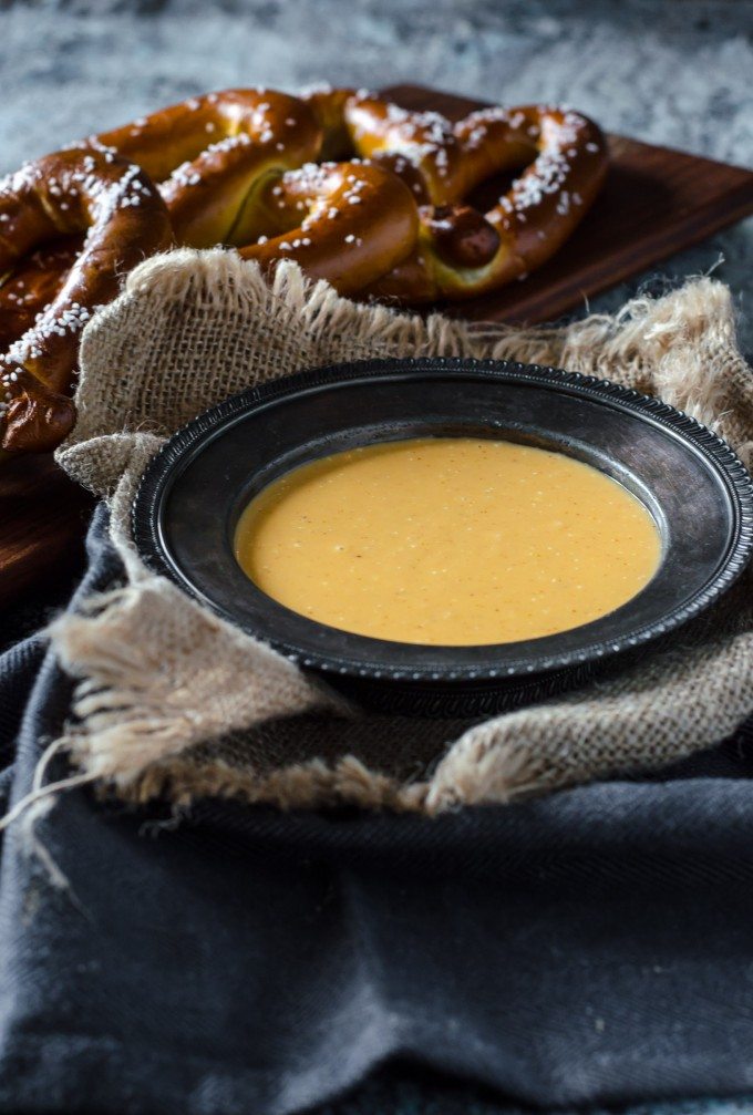 Close up of hot beer cheese dip with soft pretzels