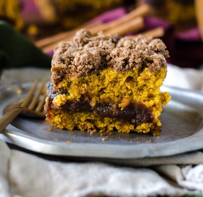 Close up of a slice of pumpkin coffee cake on a plate