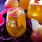 Thanksgiving recipes, apple cider fireball sangria in a polka dot glass with apples