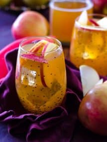 Thanksgiving recipes, apple cider fireball sangria in a polka dot glass with apples