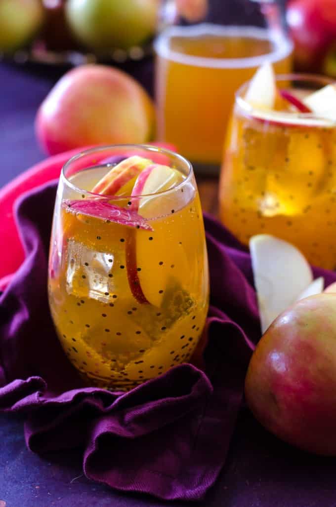 Thanksgiving recipes, apple cider fireball sangria in a polka dot glass with apples