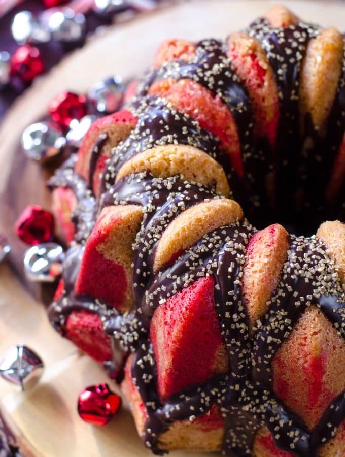 Top view of peppermint Christmas cake surrounded by jungle bells