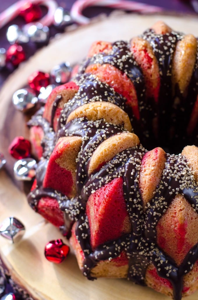 Top view of peppermint Christmas cake surrounded by jungle bells