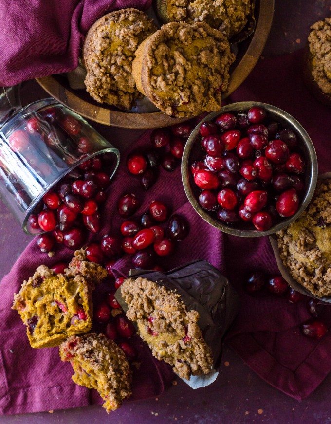 Pumpkin cranberry muffins with a bowl of cranberries