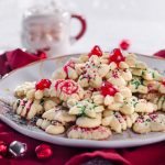 Spritz cookies on a white plate - christmas desserts