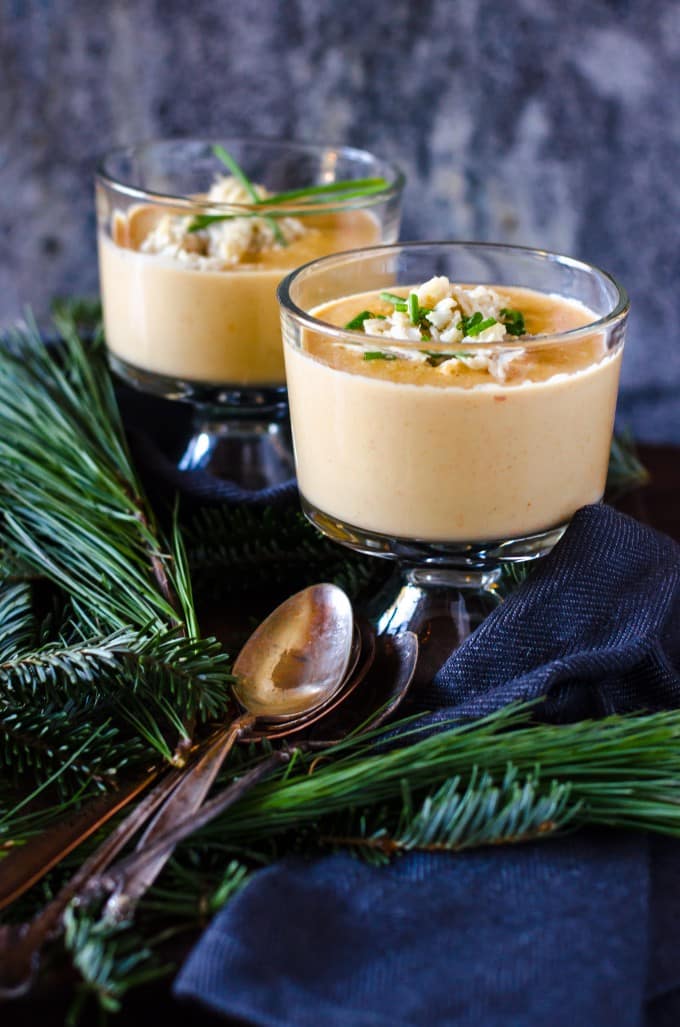 lobster bisque in two bowls with spoons