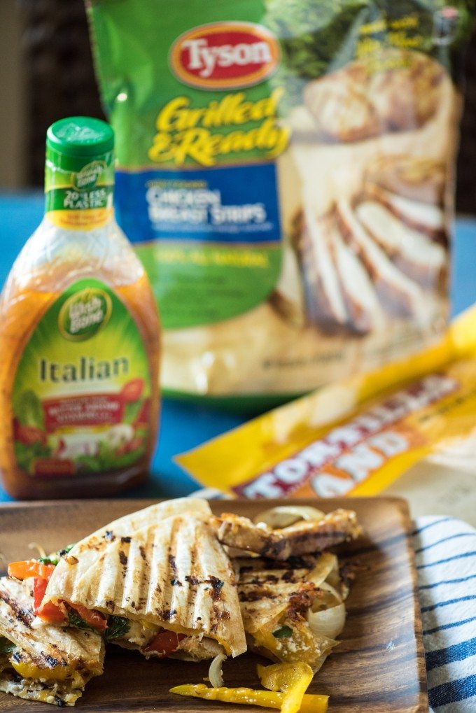 grilled chicken quesadilla panini sliced with dressing in the background