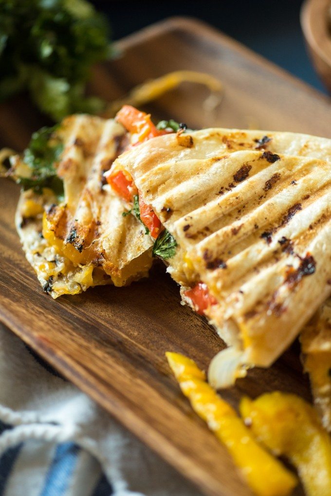 Grilled Chicken Quesadilla Panini sliced on a cutting board