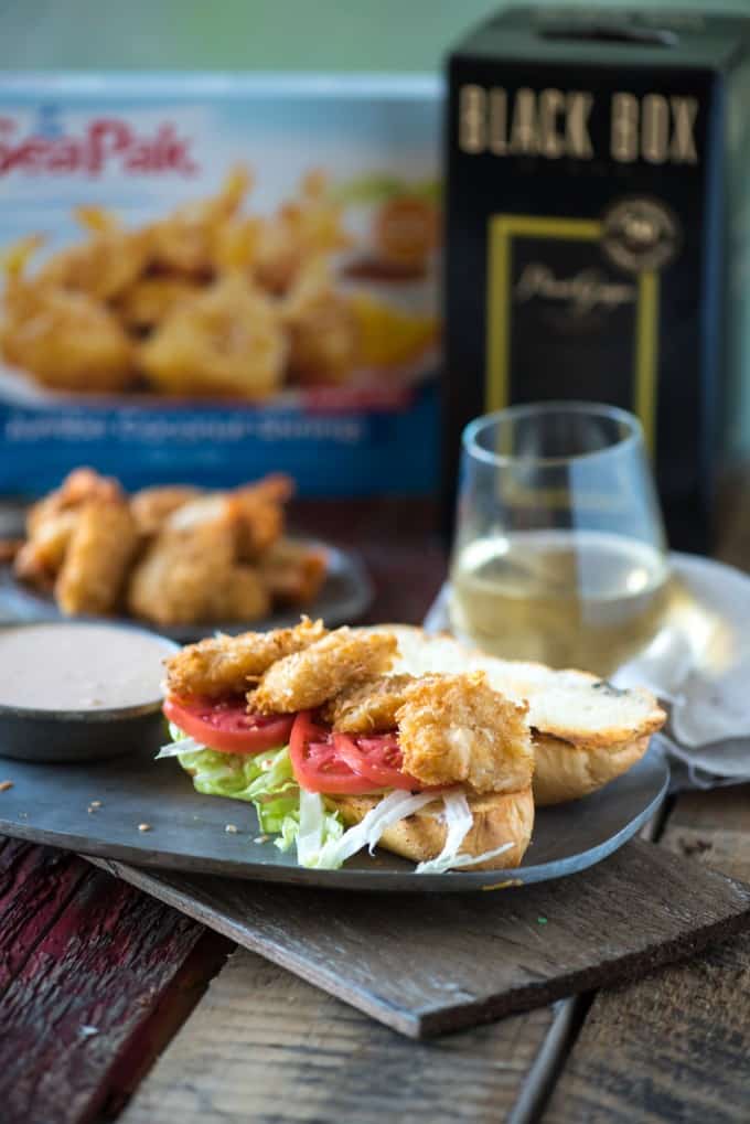 Coconut Shrimp Po Boy with a glass of wine