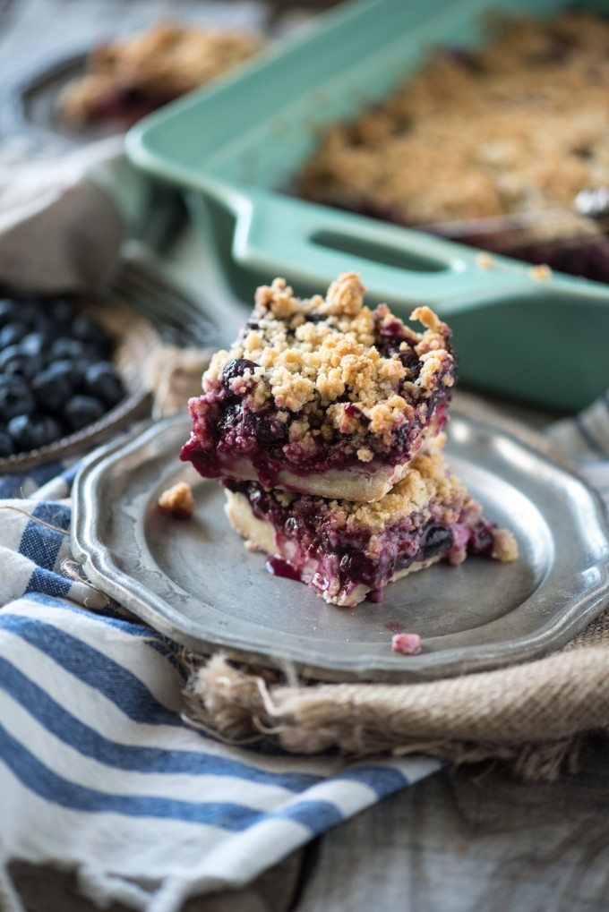 Blueberry Crumb Bars stacked on a silver plate