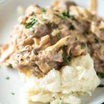 This Amish Beef and Noodles recipe can be made in a slow cooker or an Instant Pot. Served over mashed potatoes, it's an easy and loved dinner recipe!
