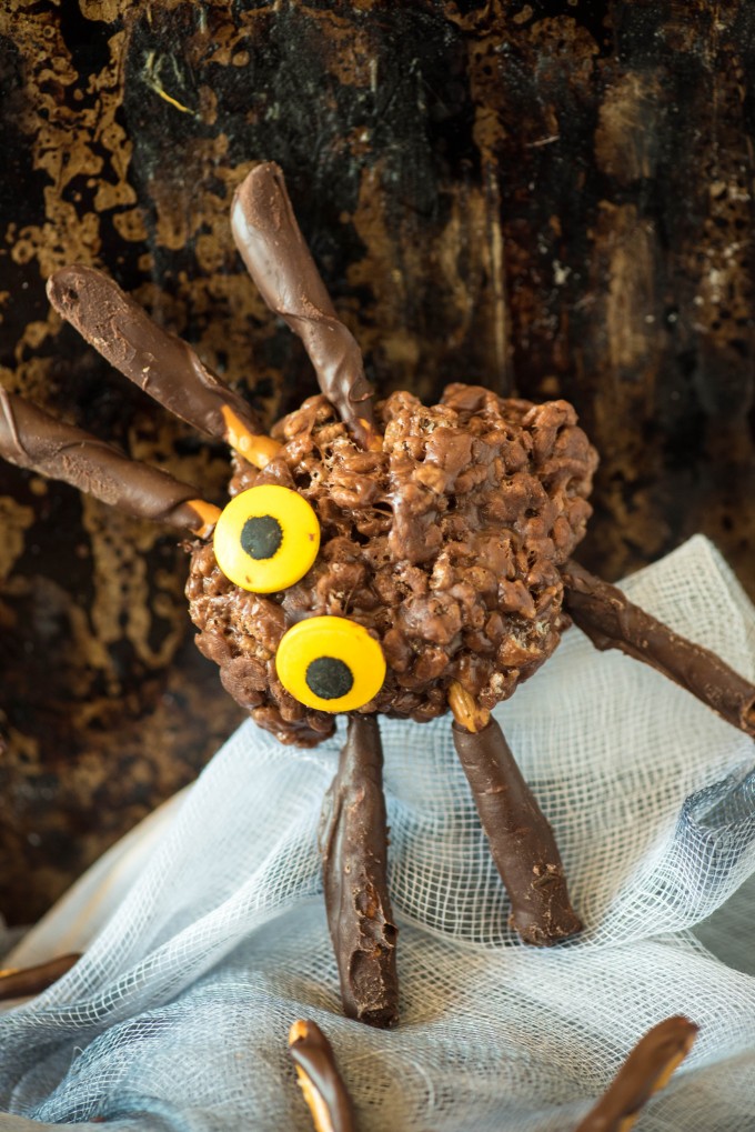 Chocolate peanut butter rice krispie treat spider with yellow eyes 