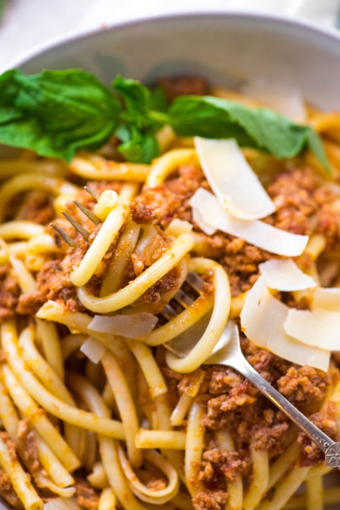 Slow Cooker Bolognese Sauce on spaghetti on fork in bowl