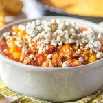 Slow Cooker Crockpot Buffalo Chicken Chili in gray bowl with yellow napkin and cornbread