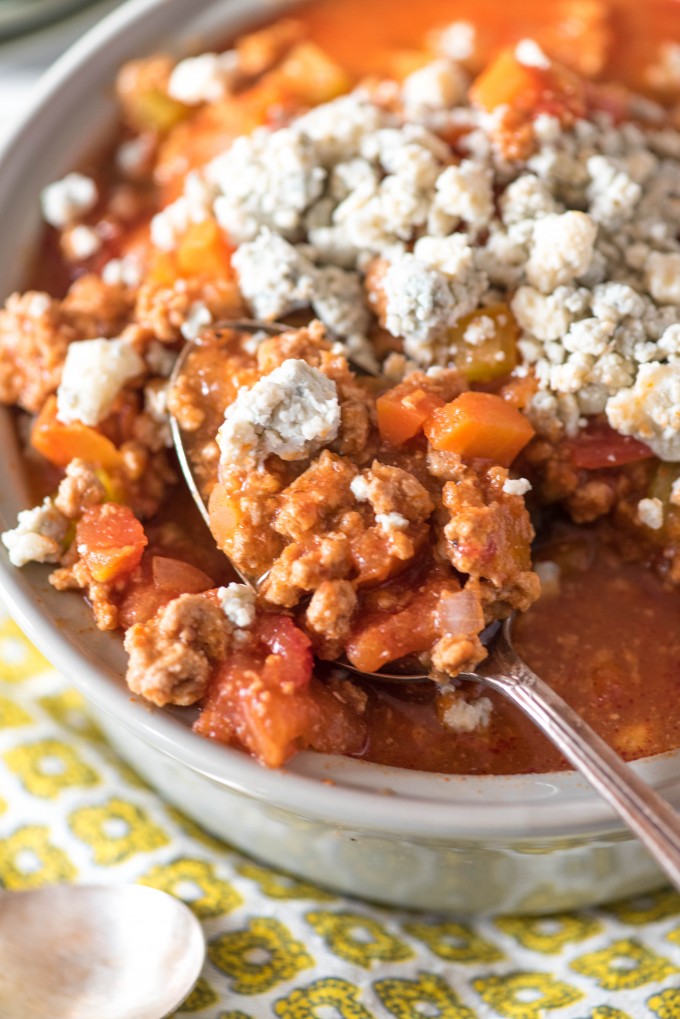 Chili on a spoon with crumbled blue cheese