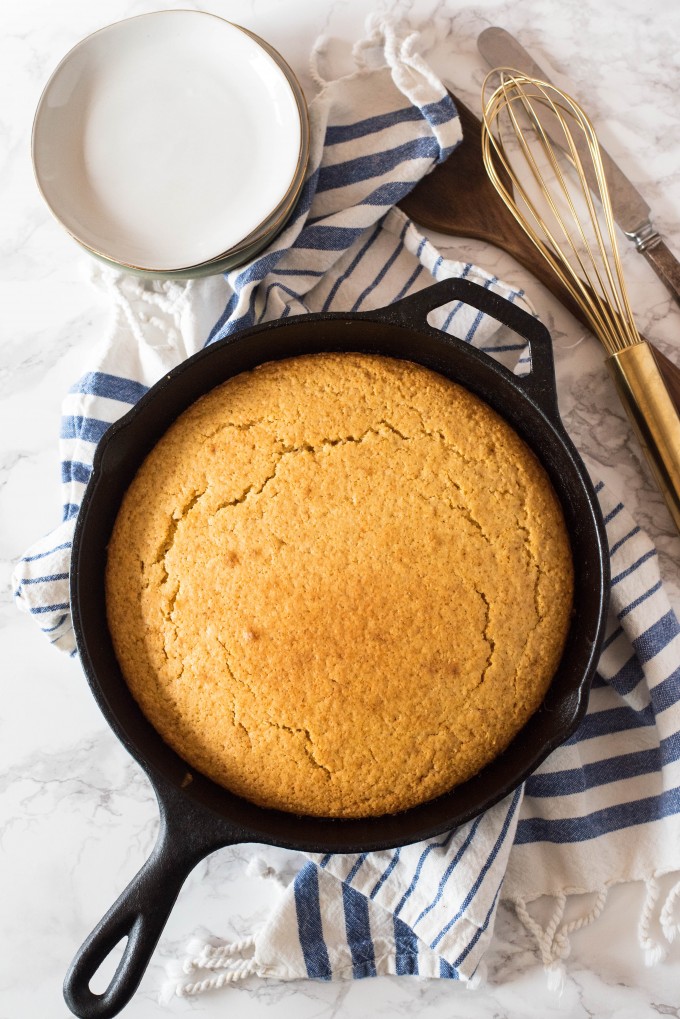 Forget the Jiffy! This homemade Easy Honey Cornbread recipe is baked in a cast iron skillet, yielding a moist inside with crispy edges and just a touch of sweetness. Pair it with my delicious honey poppyseed butter. Overhead Easy Homemade Corn Bread recipe in a cast iron skillet