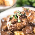 Easy Salisbury Steak recipe on white plate with mashed potatoes