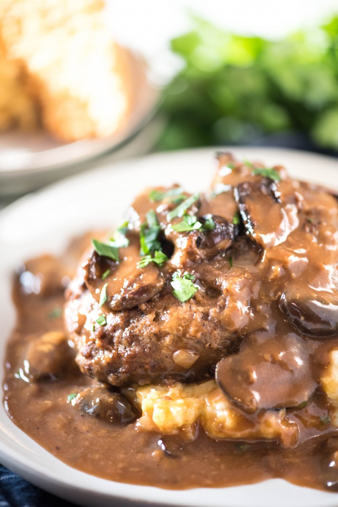 Easy Salisbury Steak recipe on white plate with mashed potatoes