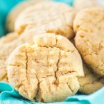 Chewy homemade peanut butter cookies on blue napkin in bowl