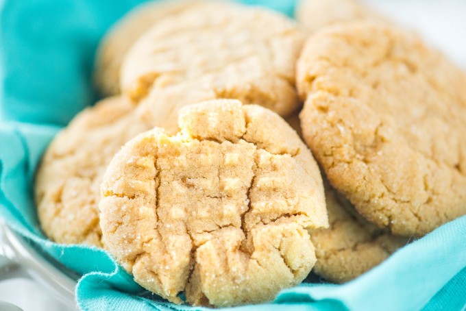 Chewy homemade peanut butter cookies on blue napkin in bowl