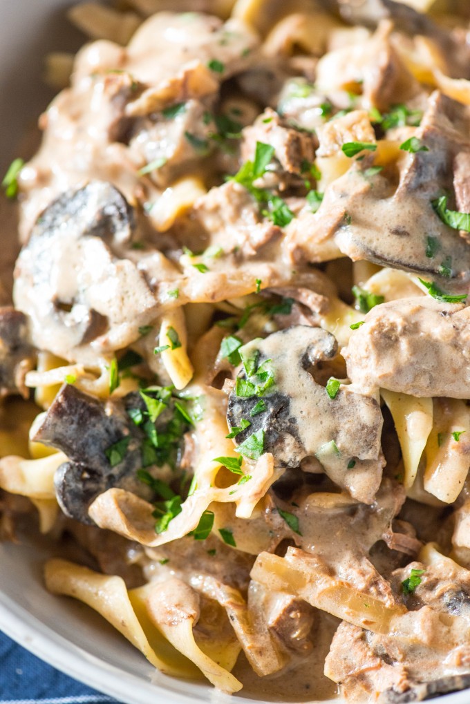 close up shot of crock pot beef stroganoff recipe over egg noodles