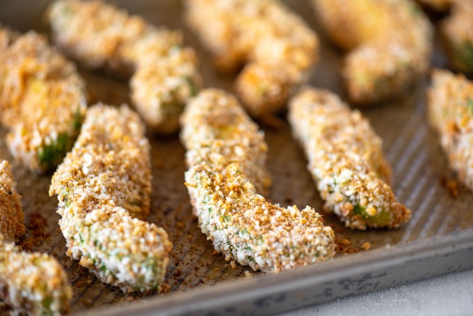 Close up of crunchy avocado fries on a baking sheet
