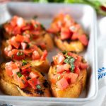 Easy tomato bruschetta with basil on baguette slices - new years eve party food