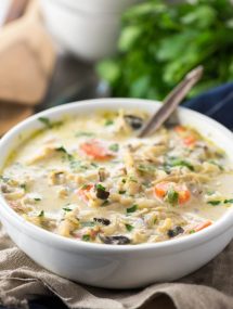 Panera Copycat Instant Pot Chicken and Wild Rice Soup in white bowl with napkin and parlsey