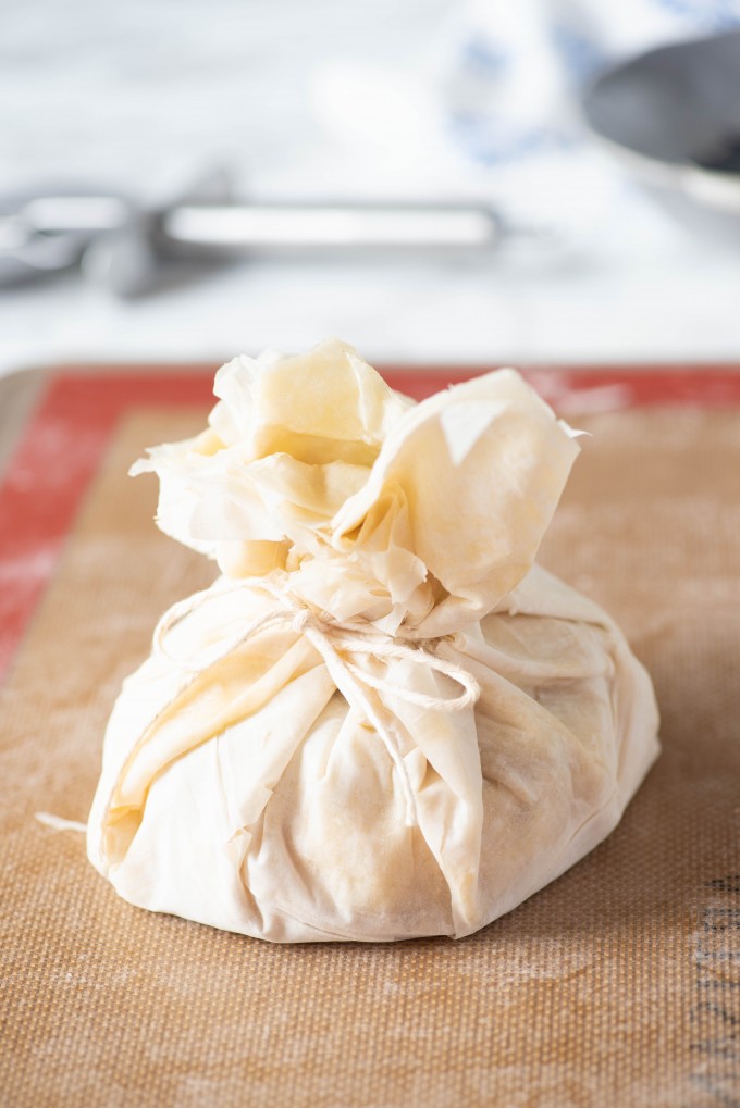 Baklava Brie wrapped with phyllo dough and tied with string