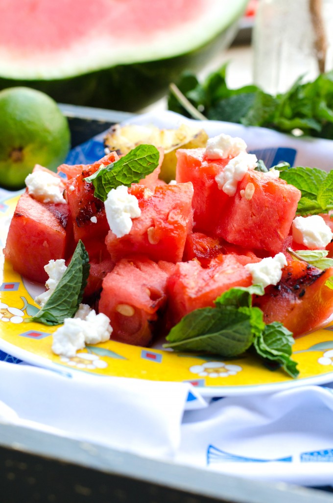 Grilled watermelon salad on a yellow dish