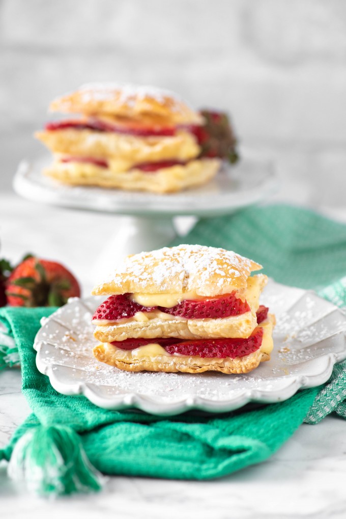 Strawberry Napoleon dessert on a white plate with a blue napkin