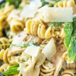 Close up of pesto pasta salad in a blue bowl