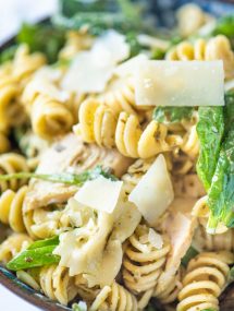 Close up of pesto pasta salad in a blue bowl